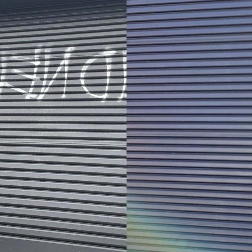 Before and after graffiti removal from a metal roller door showing complete tag removal